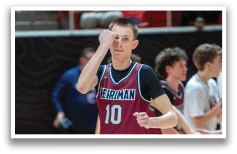 A group of young men are playing basketball on a court. One of the players is wearing a maroon jersey with the number 10 on it. AI generated content