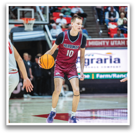 A basketball player wearing a maroon jersey and white shoes is holding a basketball. AI generated content