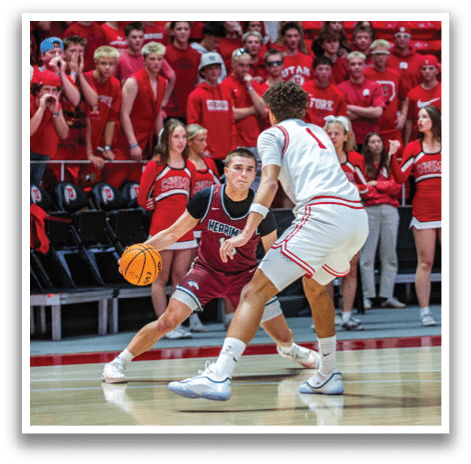 Two men playing basketball, one with a ball and the other trying to block him. AI generated content