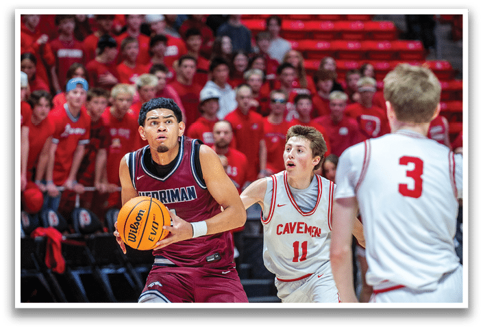 A basketball player in a maroon uniform is running with the ball while being chased by a player in a white uniform. AI generated content