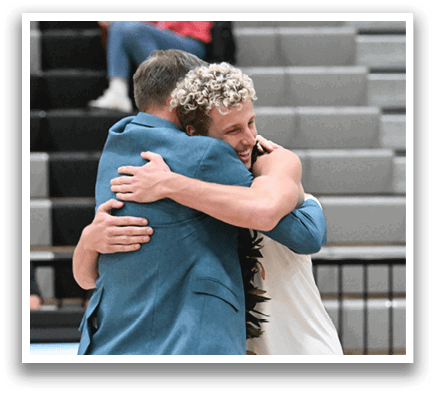 Two men hugging on a basketball court, with a woman watching. AI generated content