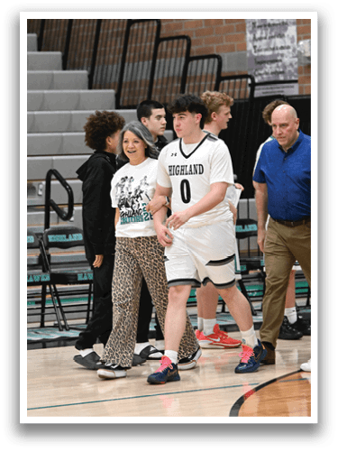 A group of people, including a woman and a man, are standing on a basketball court. The man is wearing a white jersey with the number 0 on it. The woman is wearing a leopard print outfit. AI generated content