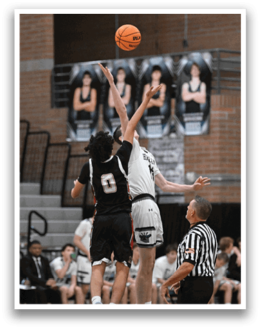Two basketball players jumping for the ball, with a referee watching closely. AI generated content