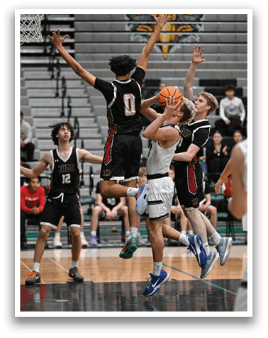 A basketball player is leaping in the air to block a shot, while other players look on. AI generated content