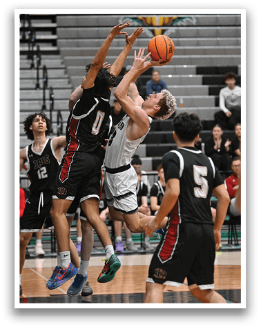 A group of men playing basketball, with one man jumping in the air to block a shot. AI generated content