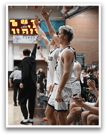 Two men are standing on a basketball court, waving to the crowd. AI generated content