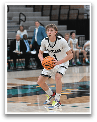 A basketball player wearing a black and white uniform holds a basketball on the court. AI generated content