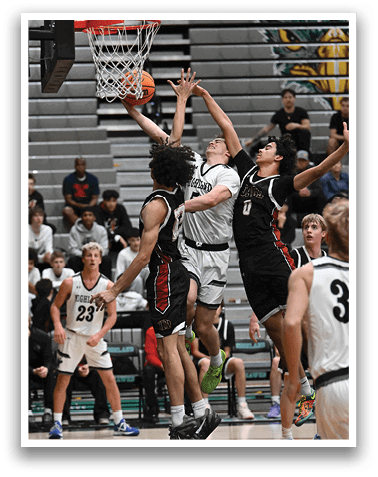 A group of men playing basketball, with one man jumping to block a shot. AI generated content