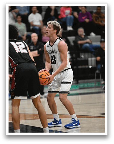 Two men playing basketball, one holding a basketball in his hands. AI generated content