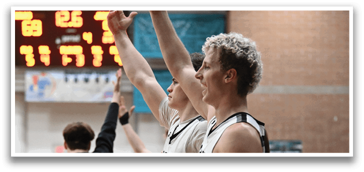 Two men are standing on a basketball court, waving to the crowd. AI generated content