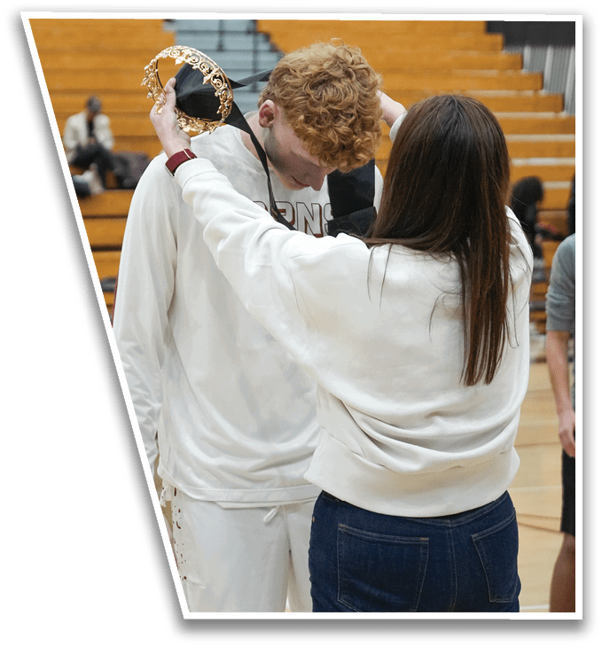 A woman is helping a man put on a gold crown. AI generated content
