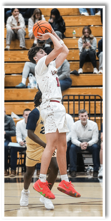 A basketball player in a white shirt and red shorts is jumping up to shoot the ball. AI generated content