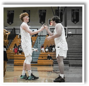 Two basketball players shake hands on the court. AI generated content