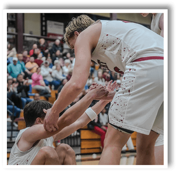 Three men are on a basketball court, with one man kneeling down and the other two standing. The man kneeling has his hands on the other man's shoulders. AI generated content
