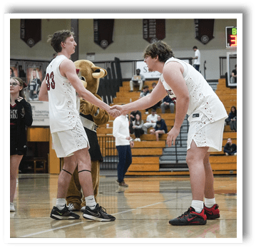 Two basketball players shake hands on the court. AI generated content
