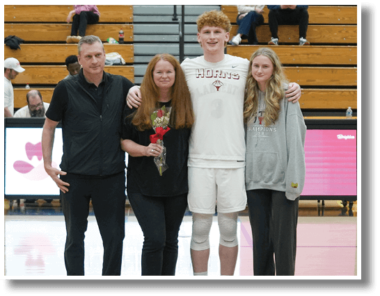 A group of people, including a man and a woman, pose for a photo on a basketball court. AI generated content