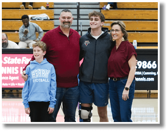 A man, woman, and child pose for a photo on a basketball court. AI generated content
