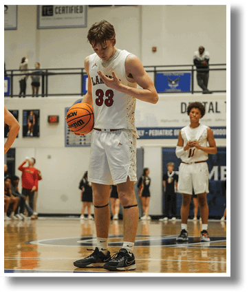 A basketball player wearing a red jersey holds a basketball on the court. AI generated content