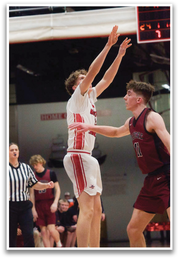 A basketball game is in progress with players on the court. A man is jumping in the air to shoot the ball. The referee is watching the play closely. AI generated content