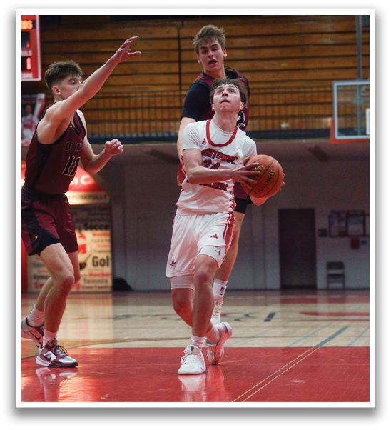 A basketball game is taking place in a gym with players on the court. One player is holding a basketball, while another player is trying to block him. The players are wearing uniforms and are actively engaged in the game. AI generated content