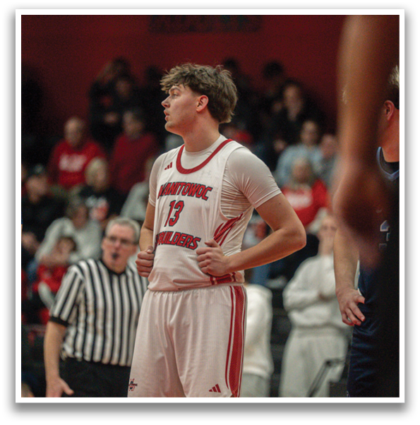 A basketball player wearing a red and white uniform stands on the court, looking up at the ceiling. AI generated content