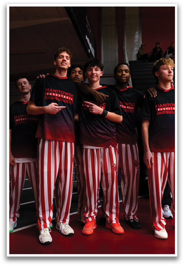 A group of young men wearing black and red striped pants pose for a picture. AI generated content
