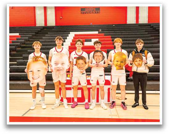 A group of young men pose for a picture on a basketball court. AI generated content
