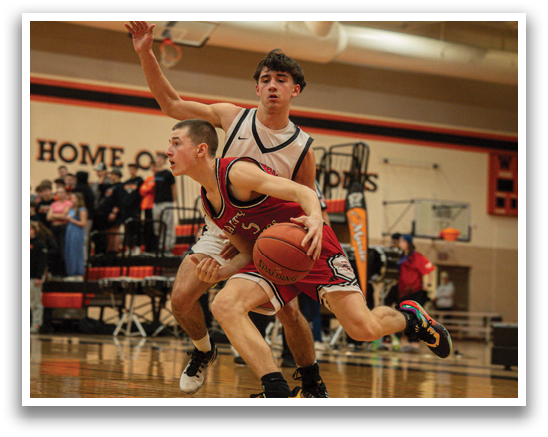 Two men are playing basketball, one is trying to block the other's shot. AI generated content