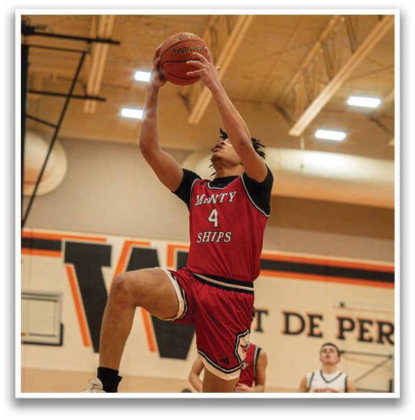 A basketball player in a red and black uniform leaps to catch a basketball. AI generated content