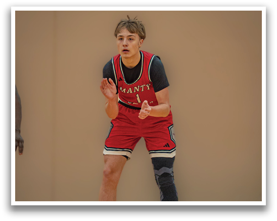 A basketball player wearing a red jersey and black shorts is standing on the court. AI generated content