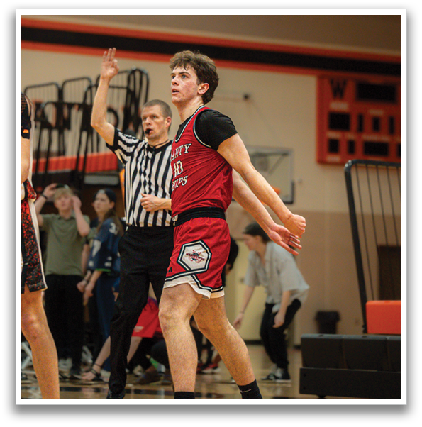 A basketball player wearing a red jersey and black shorts is walking on the court. AI generated content