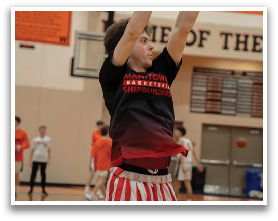 A man in a basketball court is wearing red and white striped pants and a black shirt. AI generated content