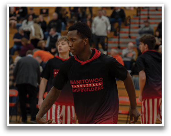 A basketball player wearing a black shirt with red and white stripes is holding a basketball. AI generated content