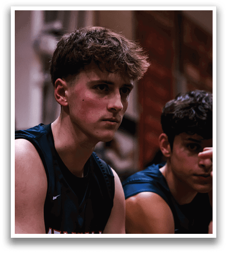 Three young men are sitting in a row, wearing sports uniforms. One of the men is pointing at the other, who is looking at him. The third man is looking at the first man. AI generated content