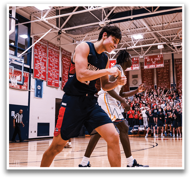 A basketball game is taking place with a crowd of people watching. A man is holding a basketball in his hands, and another man is holding a basketball in his hands as well. The players are actively engaged in the game, and the spectators are enjoying the event. AI generated content