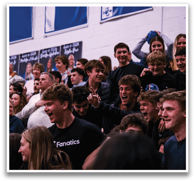 A group of people are sitting in a stadium, watching a game. They are all wearing black shirts and are excited about the event. AI generated content