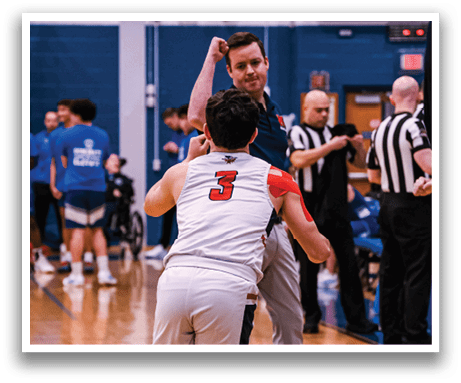 A group of people are playing basketball on a court. A man in a white shirt is running with the ball. AI generated content