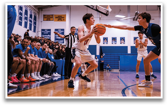 Two basketball players are fighting for the ball, while a referee watches. The players are wearing uniforms and are in the middle of the court. AI generated content