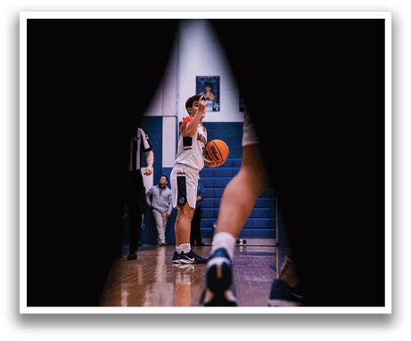 A man is holding a basketball in a gym. AI generated content