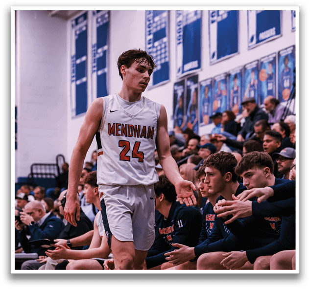 A basketball player wearing a number 24 jersey walks past a group of players sitting on the bench. AI generated content