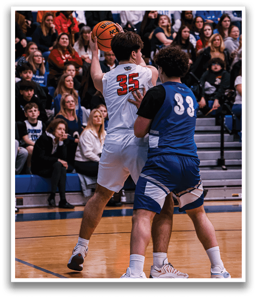 Two basketball players are fighting for the ball, with one player wearing a white jersey and the other wearing a blue jersey. The crowd is watching the intense play. AI generated content