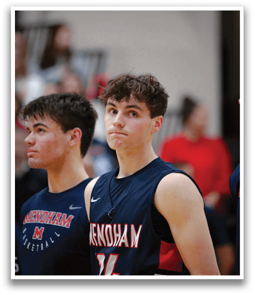 Two young men wearing blue shirts and standing on a basketball court. AI generated content