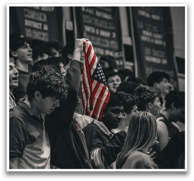 A man wearing a red, white, and blue shirt holds an American flag. AI generated content