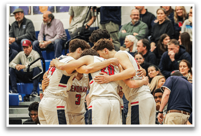 A group of men huddle together on a basketball court, with some of them wearing uniforms. They are holding hands and appear to be praying or discussing their game strategy. There are several chairs and a bench in the background, and a bottle can be seen on the ground. AI generated content