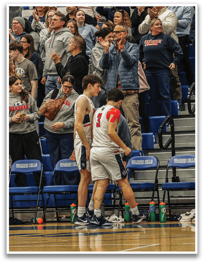 A group of people are gathered in a stadium, with some sitting on chairs and others standing. A man is holding a basketball, and a woman is holding a bottle. The crowd is cheering, and there are several chairs and bottles scattered throughout the scene. AI generated content