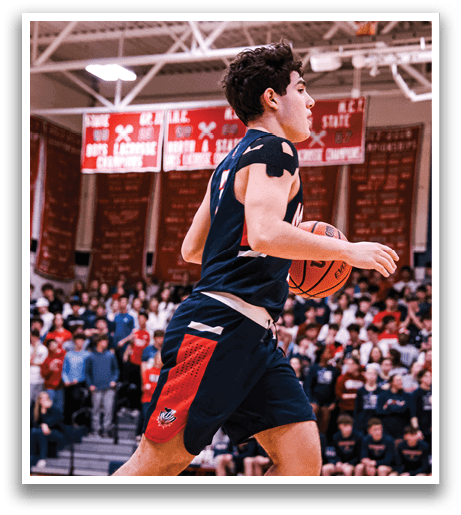 A basketball player wearing a blue shirt and black shorts is holding a basketball while running on the court. AI generated content