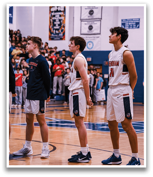 Three young men in uniform stand on a basketball court, posing for a picture. AI generated content