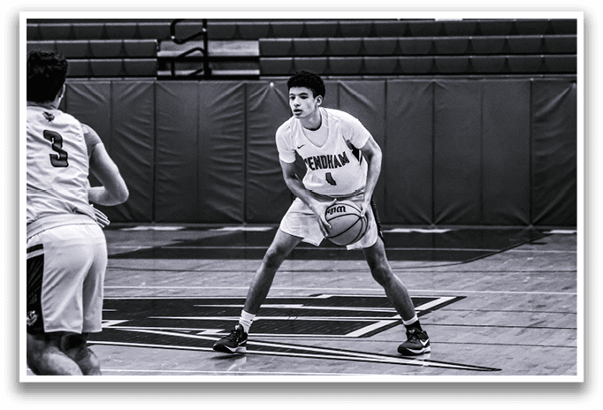 Two men playing basketball on a court. One man is holding a basketball and the other is running towards him. AI generated content