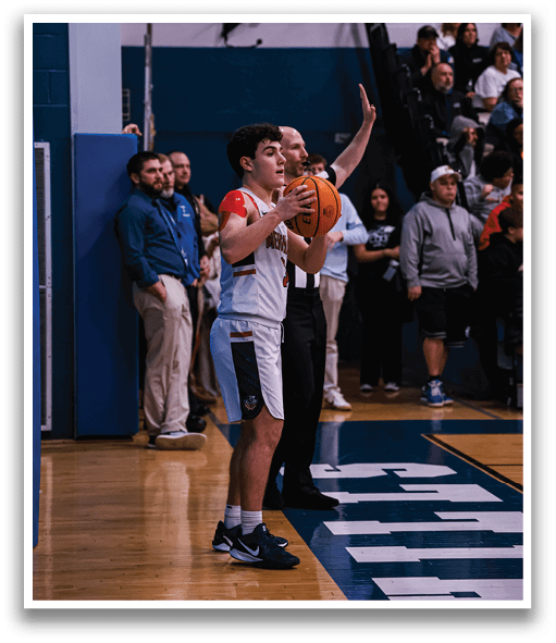 A boy holds a basketball while standing on a court. AI generated content