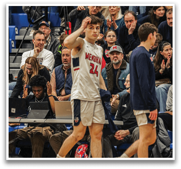 Two men are walking on a basketball court, one of them wearing a white jersey with the number 24. They are surrounded by a crowd of people, some of whom are clapping. A backpack is visible on the ground near the court. AI generated content